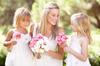 Bride and lovely flower girls in gardens